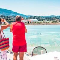 Asthma Couple on a balcony taking pictures of the landscape