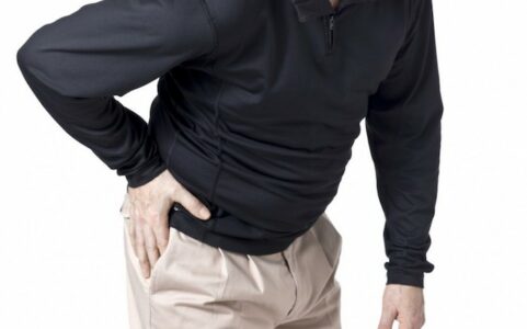 Man holding hip in pain