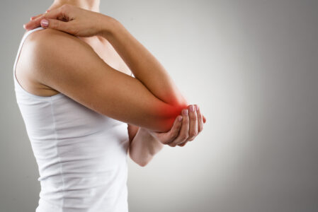 Woman holding her elbow in pain