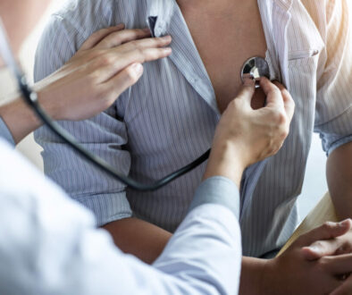 Doctor using a stethoscope checking patient with examining