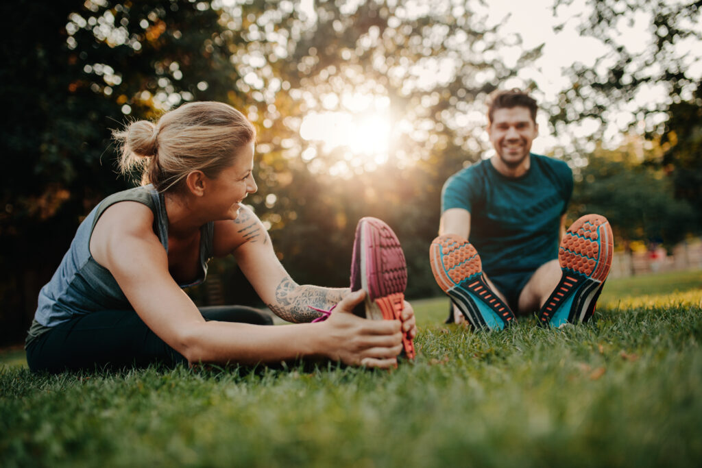 Young couple doing their stretches in the park