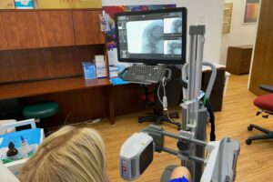 Patient at Kentuckiana Integrative Medicine Local Louisville Jeffersonville Office using Orthoscan Machine